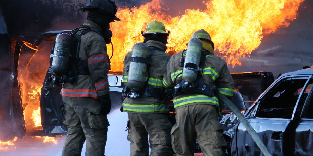 Firefighters putting out a diesel fire at a Firefighter Training camp. (copyspace)
